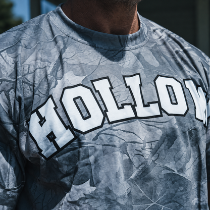 Enhanced closeup of white collegiate HOLLOW lettering and gray woodland print