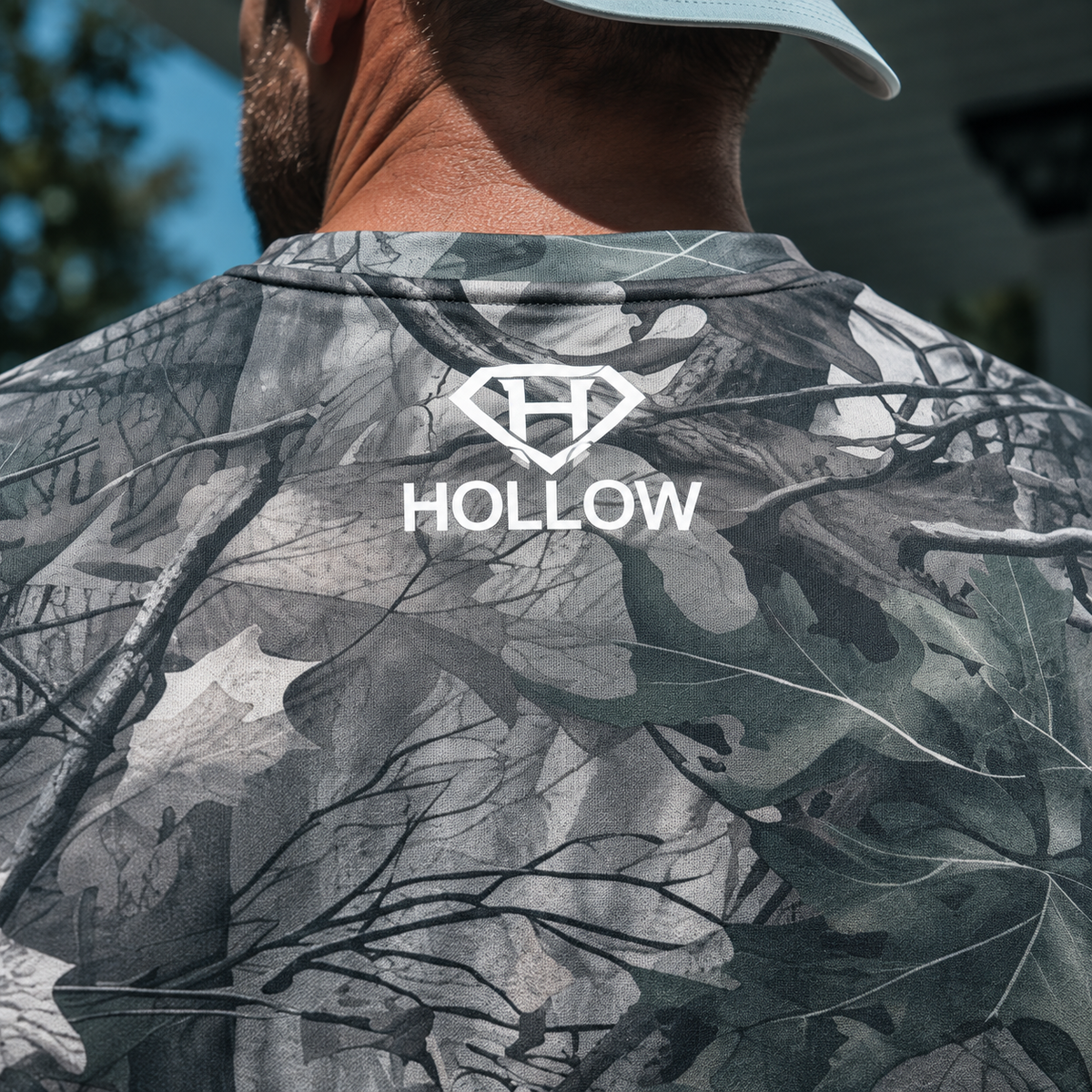 Product mockup detail of the white Hollow diamond H logo on the upper back